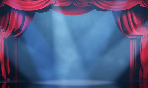 Volume light and smoke on the theater stage with red velvet curt